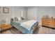 Bright bedroom with light-blue bedding and wood dresser at 5 Broadmoor Ln, Rotonda West, FL 33947