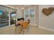 Bright dining area with a round table and chairs, and sliding doors to the backyard at 5 Broadmoor Ln, Rotonda West, FL 33947