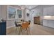 Small dining area with a round table, four chairs, and window with plantation shutters at 5 Broadmoor Ln, Rotonda West, FL 33947