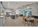 Modern kitchen with stainless steel appliances, an island, and light wood flooring at 5 Broadmoor Ln, Rotonda West, FL 33947