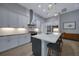 Modern kitchen with white cabinets, granite counters, and a large island at 5 Broadmoor Ln, Rotonda West, FL 33947