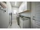 Bright laundry room with white cabinets, granite countertop and modern appliances at 5 Broadmoor Ln, Rotonda West, FL 33947