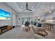 Spacious living room with a large screen TV, comfortable seating and pool view at 5 Broadmoor Ln, Rotonda West, FL 33947