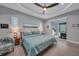Bright main bedroom with a king-size bed and sliding doors to a patio at 5 Broadmoor Ln, Rotonda West, FL 33947