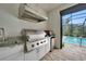 Stainless steel outdoor kitchen with built-in grill and sink at 5 Broadmoor Ln, Rotonda West, FL 33947