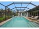 Enclosed rectangular pool with lounge chairs and a basketball hoop at 5 Broadmoor Ln, Rotonda West, FL 33947
