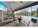 Relaxing pool area with outdoor kitchen, lounge chairs and large TV at 5 Broadmoor Ln, Rotonda West, FL 33947