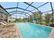 Enclosed rectangular pool with lounge chairs and a basketball hoop at 5 Broadmoor Ln, Rotonda West, FL 33947