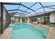 Enclosed rectangular pool with lounge chairs and a basketball hoop at 5 Broadmoor Ln, Rotonda West, FL 33947