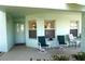 Inviting front porch with seating for two, perfect for relaxing at 5725 Greenwood Ave # 8101, North Port, FL 34287