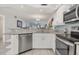 Modern kitchen with white cabinets and granite countertops at 5725 Greenwood Ave # 8101, North Port, FL 34287