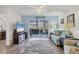 Bright living room with comfy furniture and access to a screened balcony at 5725 Greenwood Ave # 8101, North Port, FL 34287
