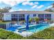 Community pool with ample seating and patio umbrellas at 5725 Greenwood Ave # 8101, North Port, FL 34287