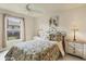 Bright bedroom features ceiling fan, floral bedding and an outside view from the bright window at 604 Boundary Blvd, Rotonda West, FL 33947
