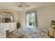 Relaxing bedroom featuring a ceiling fan, floral bedding and an outside view from the bright window at 604 Boundary Blvd, Rotonda West, FL 33947