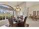 Elegant dining area featuring a decorative chandelier, large window for natural light, and stylish furnishings at 604 Boundary Blvd, Rotonda West, FL 33947