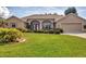Inviting single-story home with manicured lawn and mature landscaping creating great curb appeal at 604 Boundary Blvd, Rotonda West, FL 33947
