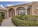 Close-up of the front entrance with well-maintained landscaping and a beautiful doorway at 604 Boundary Blvd, Rotonda West, FL 33947
