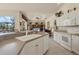 Well-lit kitchen featuring white cabinetry, modern appliances, and seamless view into the living area at 604 Boundary Blvd, Rotonda West, FL 33947
