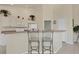 Open kitchen with white cabinetry, breakfast bar with seating, and modern appliances at 604 Boundary Blvd, Rotonda West, FL 33947