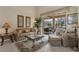 Comfortable living room with neutral tones, tile floors and views of the pool and lanai at 604 Boundary Blvd, Rotonda West, FL 33947