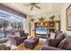 Cozy living room area with comfortable seating and a large window showcasing pool views at 604 Boundary Blvd, Rotonda West, FL 33947