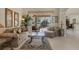 Bright living room featuring neutral tones, tile flooring, and an expansive view of the screened lanai and pool area at 604 Boundary Blvd, Rotonda West, FL 33947