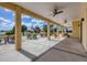 A covered outdoor patio with ceiling fans and views of a lake at 604 Boundary Blvd, Rotonda West, FL 33947