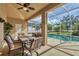 Inviting covered patio featuring a ceiling fan and views of the sparkling pool at 604 Boundary Blvd, Rotonda West, FL 33947