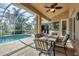 Relaxing pool and lanai area with ceiling fan and beautiful patio furniture at 604 Boundary Blvd, Rotonda West, FL 33947