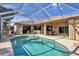 Screened-in pool area perfect for outdoor entertaining with ample seating and dining space at 604 Boundary Blvd, Rotonda West, FL 33947