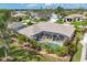 A screened-in pool with tropical landscaping offers a private backyard retreat at 604 Boundary Blvd, Rotonda West, FL 33947