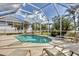 Inviting screened-in pool with lounge chairs and a view of the lush landscaping at 604 Boundary Blvd, Rotonda West, FL 33947