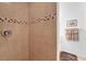 Shower with ceramic tiles, built-in shower head, and chrome fixtures at 6125 Higgins Ln, Englewood, FL 34224