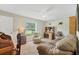 Comfortable bedroom with a ceiling fan, neutral color palette, and plush beige carpeting at 6125 Higgins Ln, Englewood, FL 34224