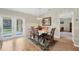 Dining room with a wood table set on a rug and a sliding glass door for natural light at 6125 Higgins Ln, Englewood, FL 34224