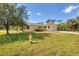 A quaint yellow home with an attached garage and green lawn at 6125 Higgins Ln, Englewood, FL 34224