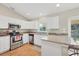 Kitchen featuring stainless steel appliances, white cabinets, granite countertops, and outdoor access at 6125 Higgins Ln, Englewood, FL 34224