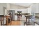 Bright kitchen with stainless steel appliances, granite countertops, and breakfast bar seating at 6125 Higgins Ln, Englewood, FL 34224