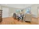Bright living room with wood floors, comfortable seating, and natural light at 6125 Higgins Ln, Englewood, FL 34224