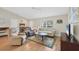 Inviting living room with vaulted ceilings and wood flooring at 6125 Higgins Ln, Englewood, FL 34224
