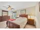 Main bedroom with wooden furniture, and natural light from the window at 6125 Higgins Ln, Englewood, FL 34224