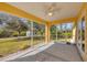 Covered and screened patio with an exterior view of the backyard at 6125 Higgins Ln, Englewood, FL 34224
