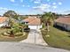 Single-Gathering home with a two-car garage and lush landscaping at 6730 Greenview Ln, Englewood, FL 34224