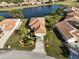 Bird's-eye view of a house near a lake in a residential community at 6730 Greenview Ln, Englewood, FL 34224
