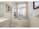 Bathroom with large soaking tub and window at 6730 Greenview Ln, Englewood, FL 34224