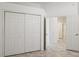 Bedroom with double door closet and access to hallway at 6730 Greenview Ln, Englewood, FL 34224