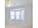 Bright bedroom with bay window and ceiling fan at 6730 Greenview Ln, Englewood, FL 34224
