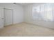 Well-lit bedroom featuring a double door closet and window with sheer white curtains at 6730 Greenview Ln, Englewood, FL 34224