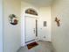 White front door with decorative accents and welcome mat at 6730 Greenview Ln, Englewood, FL 34224